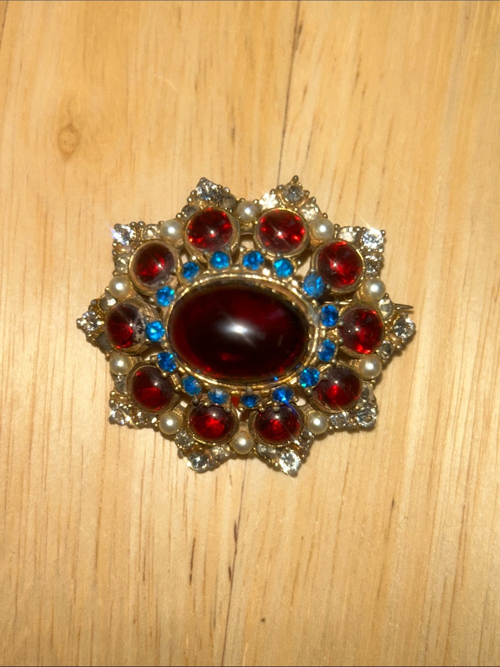 Spinx Signed Gold-Tone Vintage Brooch with Garnet-Red Cabochons and Blue Accents